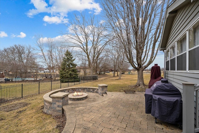 view of patio featuring an outdoor fire pit, area for grilling, and fence