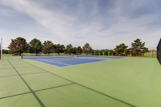 view of tennis court featuring fence