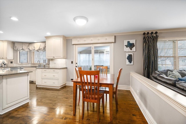 dining room with crown molding, baseboards, dark wood-type flooring, and recessed lighting