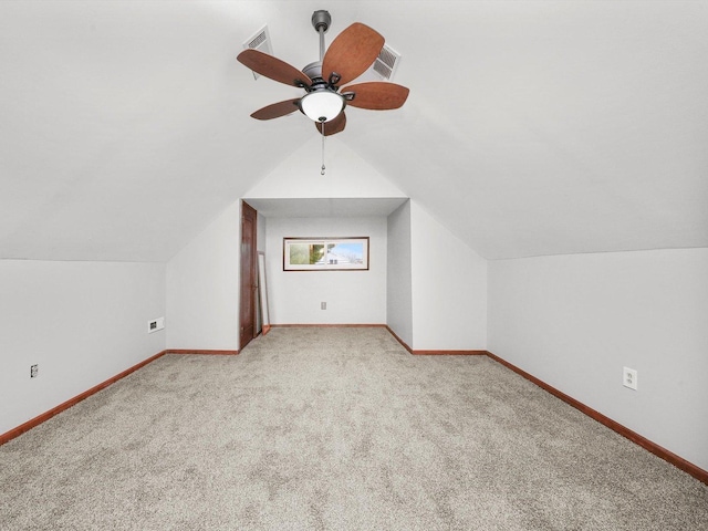 additional living space with ceiling fan, light colored carpet, and lofted ceiling