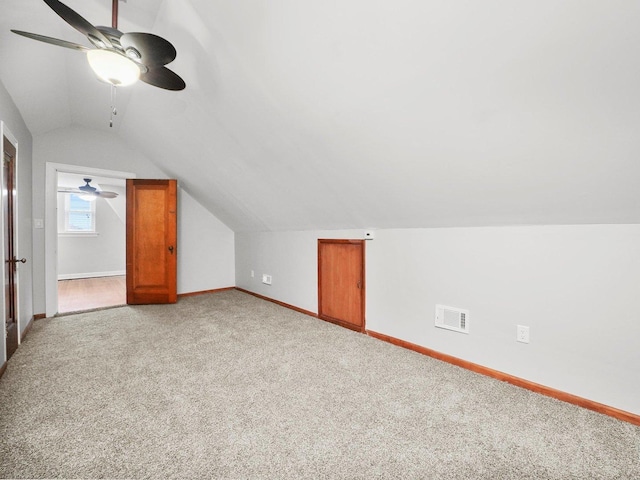 additional living space with ceiling fan, light carpet, and vaulted ceiling