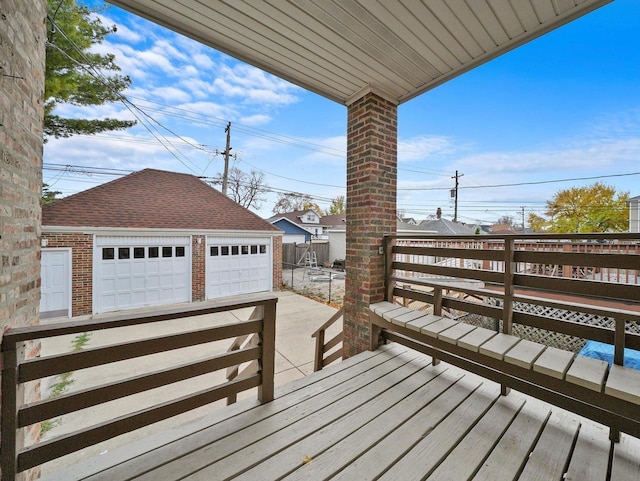 deck featuring a garage and an outbuilding