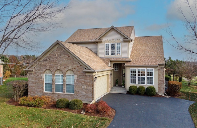 front of property with a front lawn and a garage