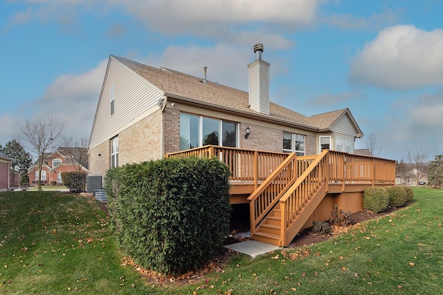 rear view of property with a lawn and a deck