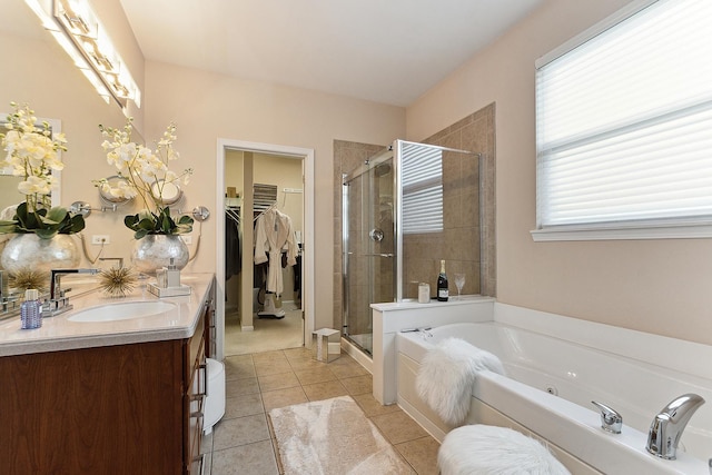 bathroom featuring plus walk in shower, tile patterned flooring, and vanity