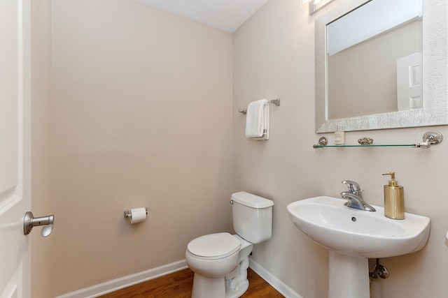 bathroom featuring hardwood / wood-style flooring and toilet