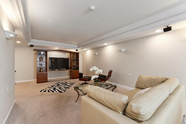 carpeted living room featuring a tray ceiling