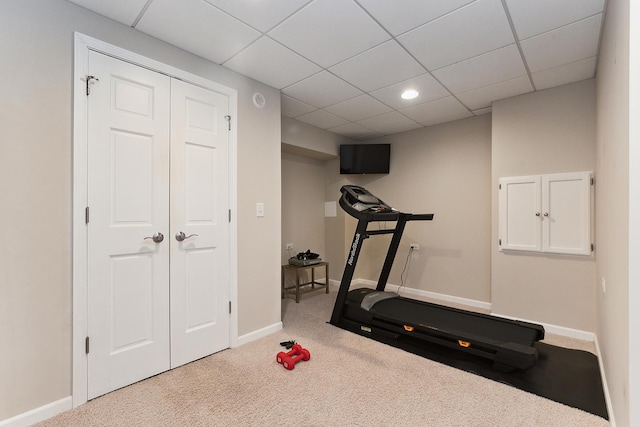 exercise area with a drop ceiling and carpet floors