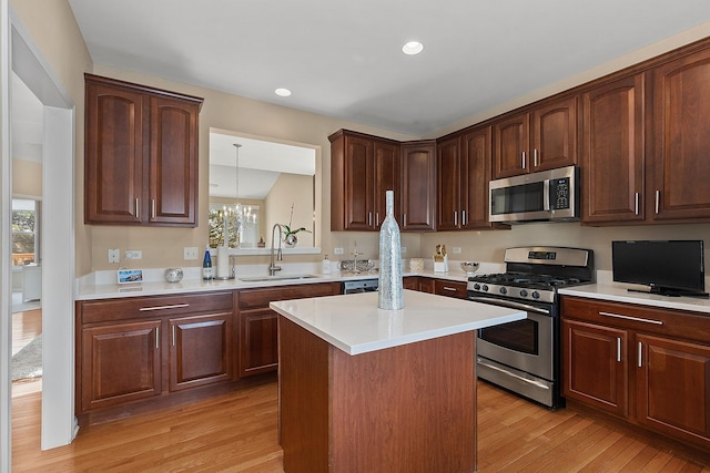 kitchen with sink, stainless steel appliances, plenty of natural light, and light wood-type flooring