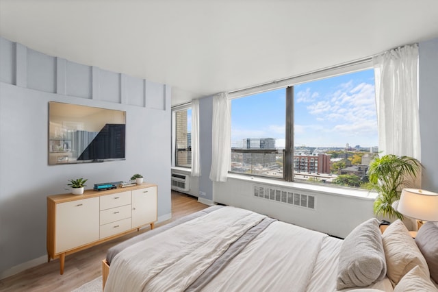 bedroom featuring light wood-type flooring and radiator