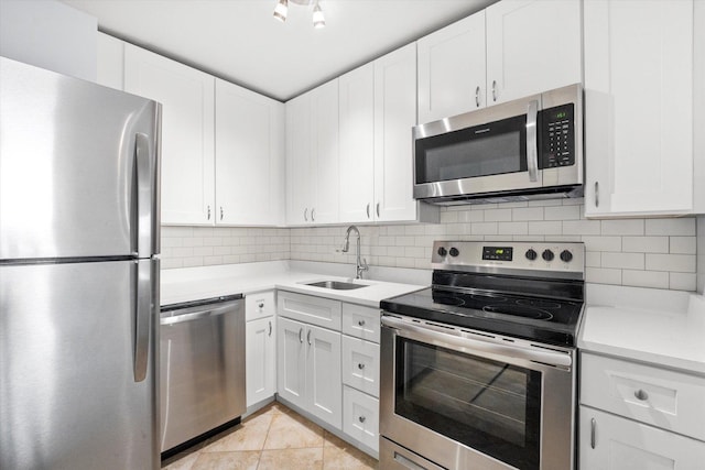 kitchen featuring stainless steel appliances, white cabinetry, and sink