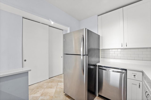 kitchen featuring white cabinets, stainless steel appliances, and tasteful backsplash