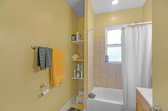 bathroom featuring shower / bath combination with curtain and vanity