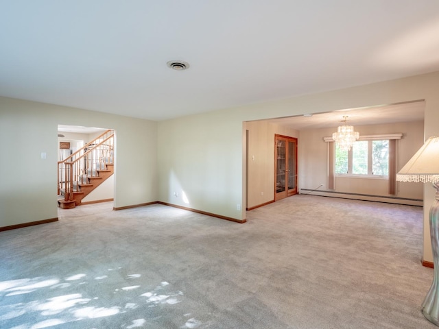 empty room with light carpet, baseboard heating, and a notable chandelier