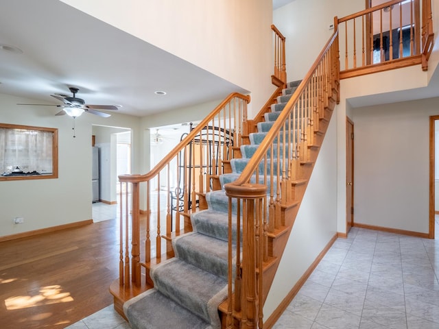 stairs with ceiling fan and wood-type flooring