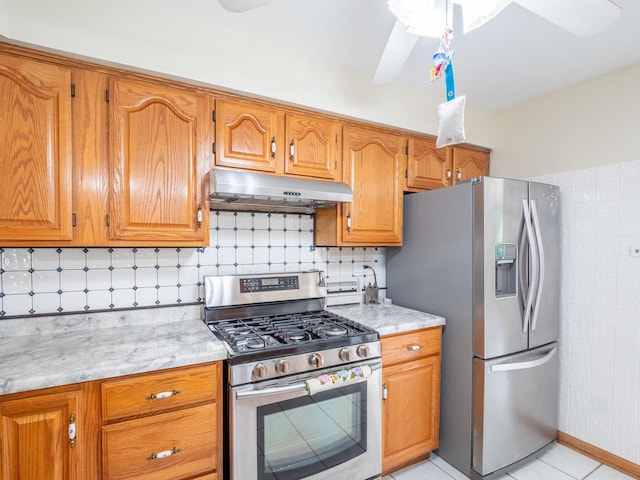 kitchen featuring decorative backsplash, light tile patterned floors, and stainless steel appliances