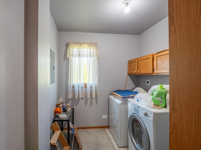 laundry area featuring washing machine and clothes dryer, electric panel, light colored carpet, and cabinets