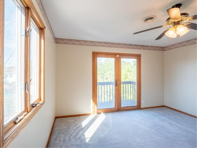 unfurnished room featuring carpet, ceiling fan, ornamental molding, and french doors