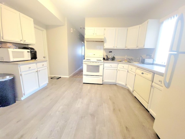 kitchen featuring white cabinets, white appliances, light hardwood / wood-style floors, and sink