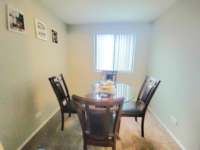 dining space with carpet flooring