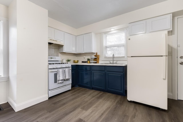 kitchen featuring white appliances, blue cabinets, sink, dark hardwood / wood-style floors, and white cabinetry