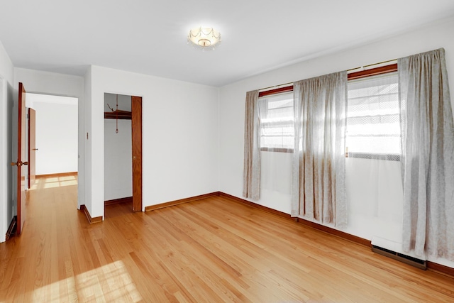 unfurnished bedroom with a closet and wood-type flooring