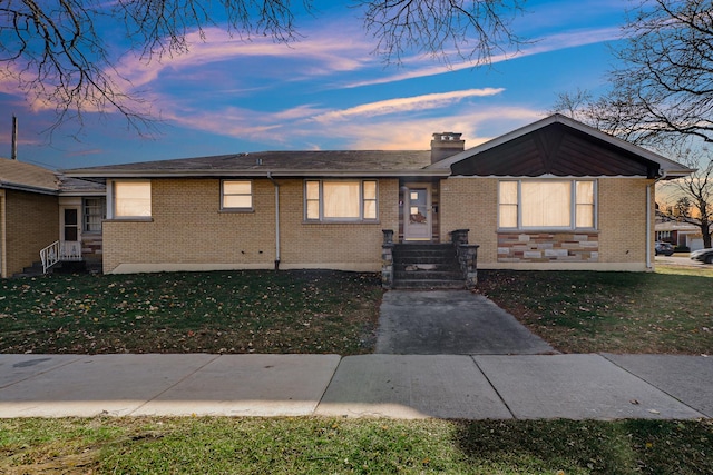 view of front of property with a lawn