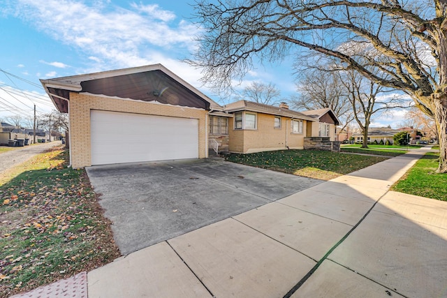 ranch-style house with a garage and a front yard