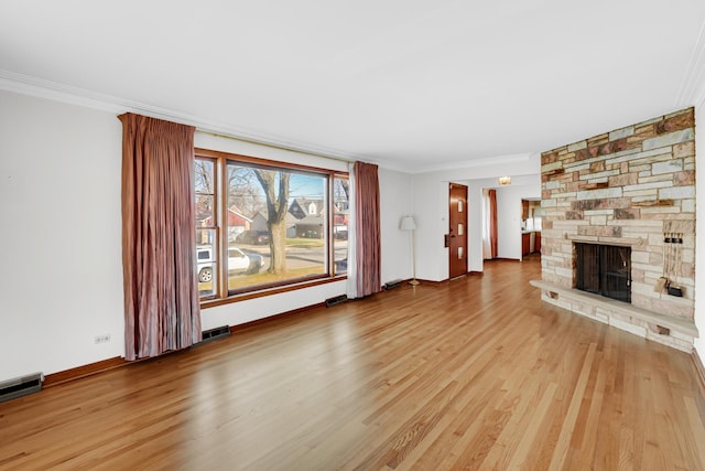 unfurnished living room with a fireplace, light hardwood / wood-style floors, and ornamental molding