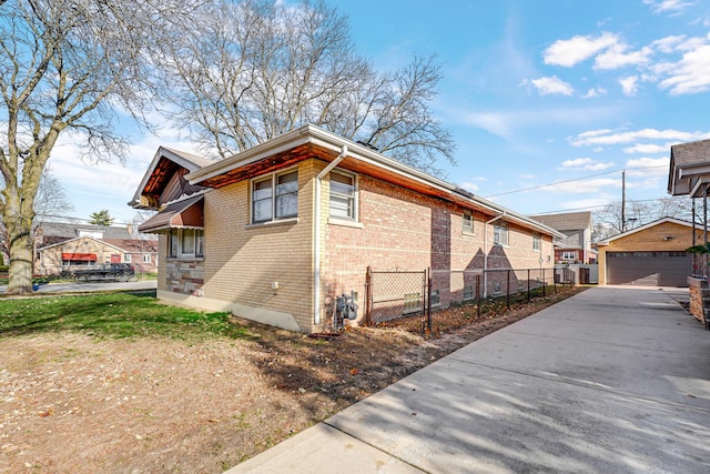 view of side of property featuring a garage and an outdoor structure