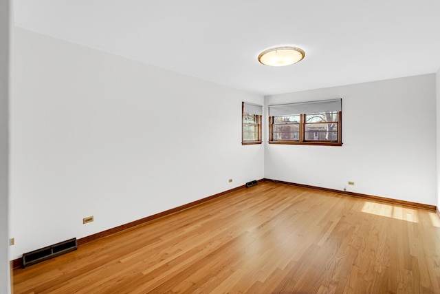 spare room with light hardwood / wood-style floors