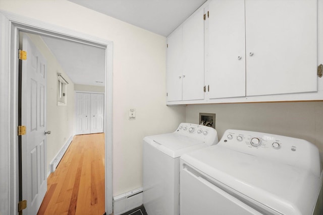 laundry room featuring light hardwood / wood-style floors, cabinets, and independent washer and dryer