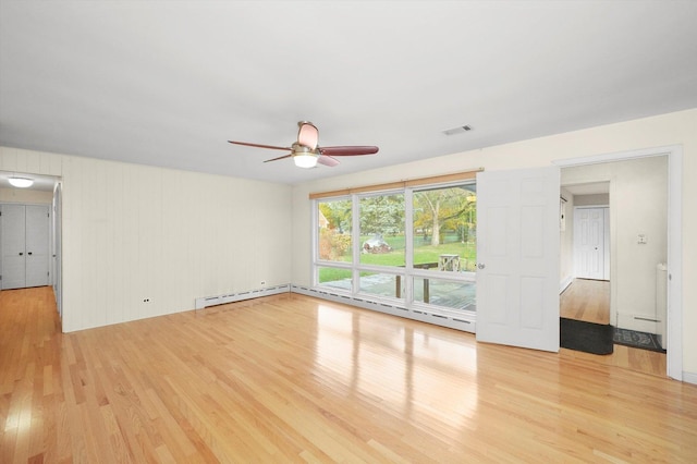 unfurnished living room with ceiling fan, light wood-type flooring, and baseboard heating