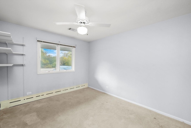 spare room with carpet, ceiling fan, and a baseboard radiator