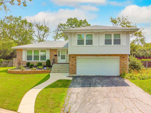 tri-level home with a front lawn and a garage