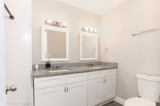 bathroom featuring vanity and toilet