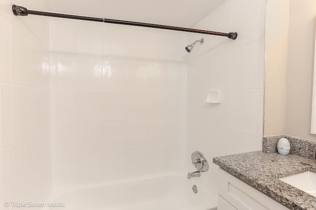 bathroom with vanity and tiled shower / bath combo