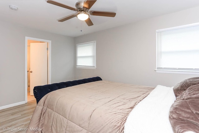 bedroom with light hardwood / wood-style floors and ceiling fan