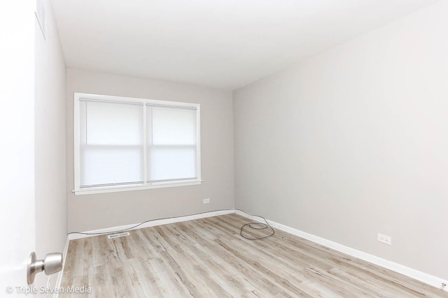 spare room with light wood-type flooring