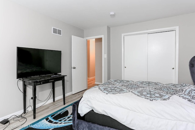 bedroom with hardwood / wood-style flooring and a closet