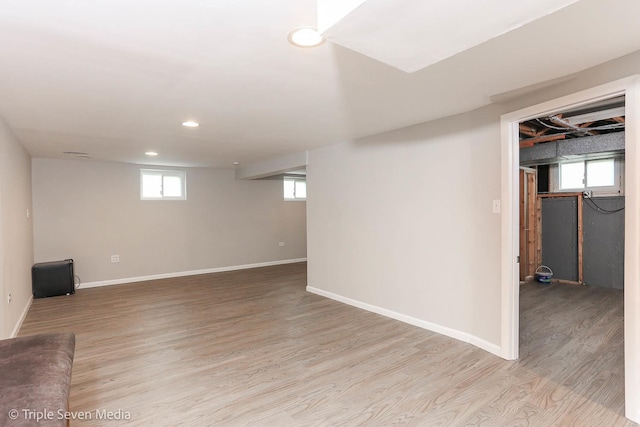 basement featuring plenty of natural light and light wood-type flooring