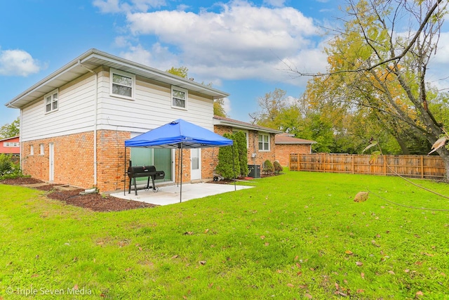 back of property featuring a patio, central AC unit, and a lawn