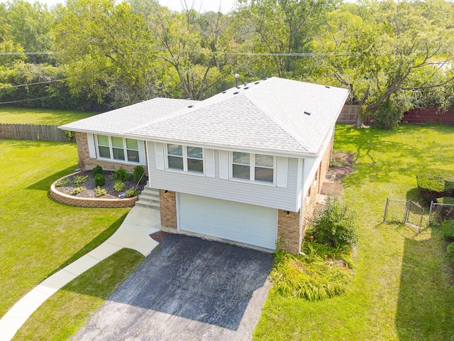 view of front of property with a front yard and a garage