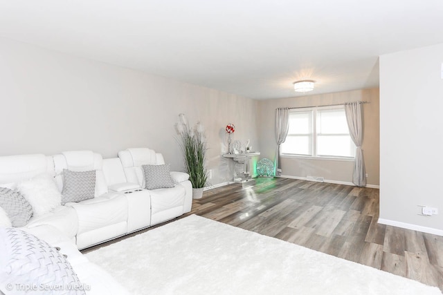 unfurnished living room with wood-type flooring