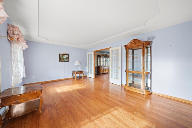 interior space with french doors and light hardwood / wood-style floors