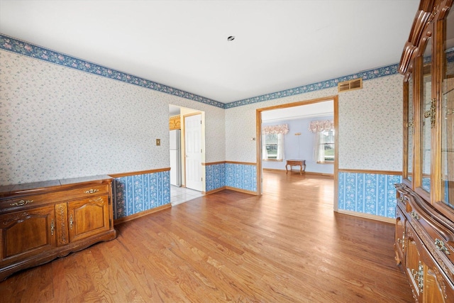 empty room with light hardwood / wood-style floors