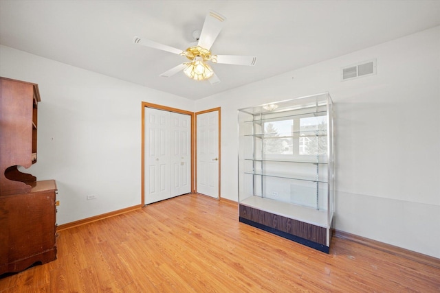 empty room featuring ceiling fan and light hardwood / wood-style flooring