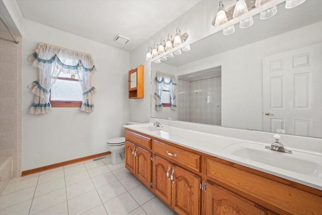 bathroom featuring tile patterned floors, vanity, and toilet