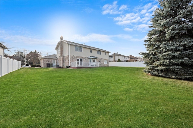 rear view of property featuring a lawn