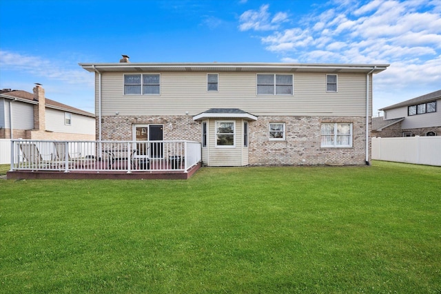 back of property featuring a yard and a deck